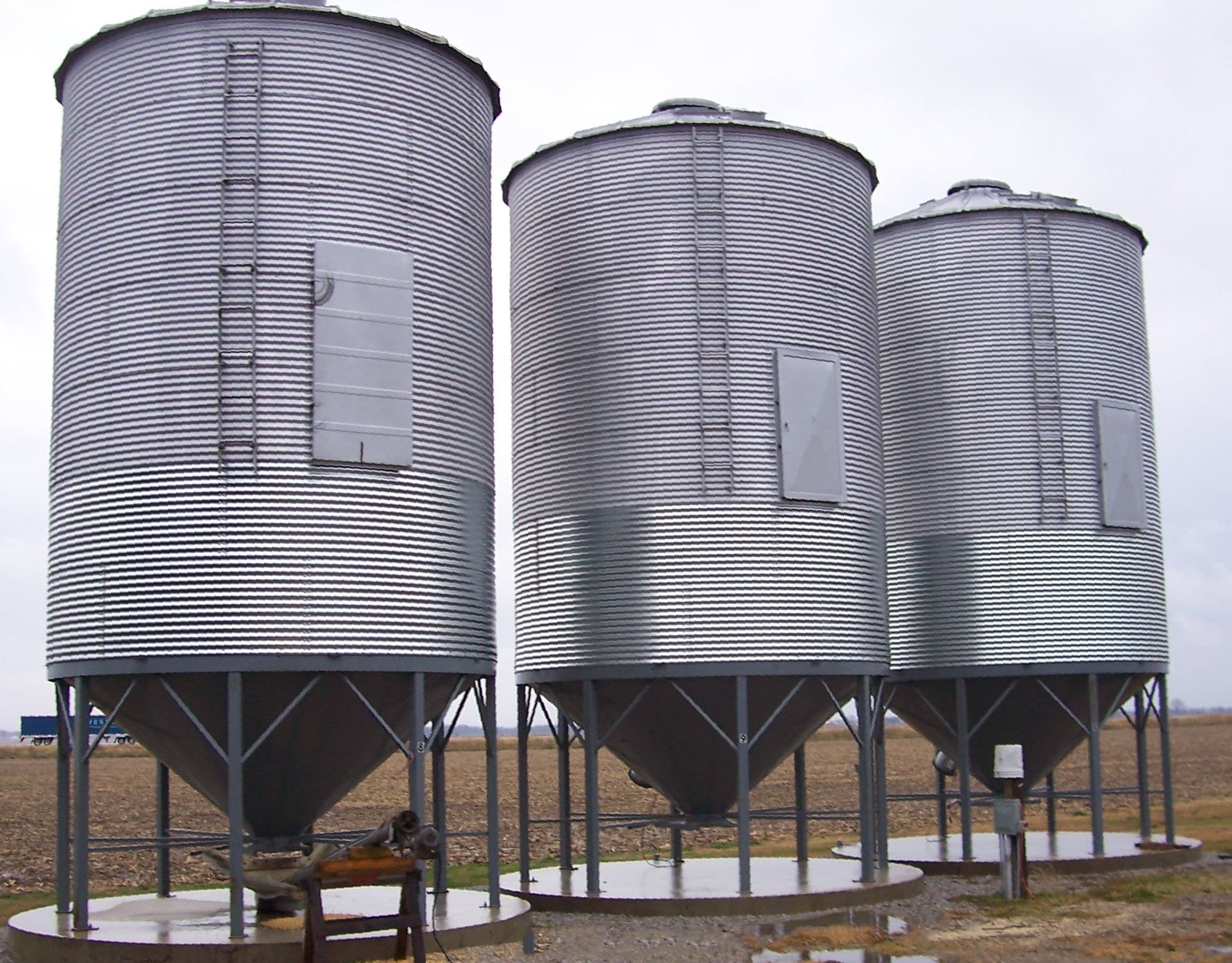 3 grain bins with hopper bottom cones
